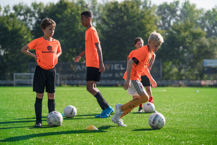 niños jugando al futbol en el campamento de verano en holanda