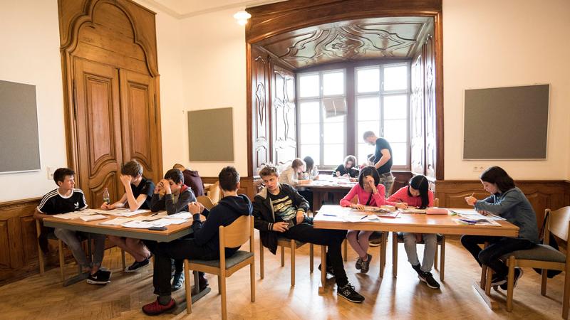 Grupo de jóvenes en una de las salas de estudio de los campamentos Harry Potter estudiando conjuros