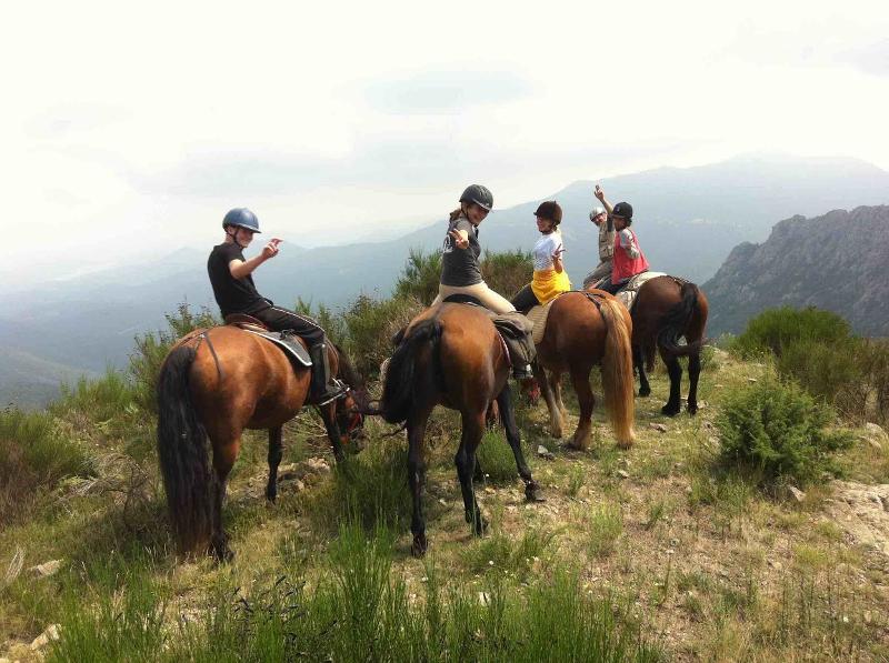 Grupo de jovenes montando a caballo por la naturaleza del campamento de verano en francia