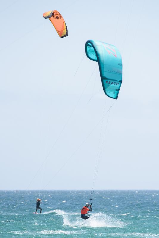 Joven practicando Kitesurf junto con su monitor en la playa del campamento de verano en Cádiz