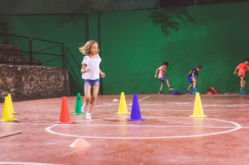 niña realizando uno de los juegos nocturnos del campamento de verano en tarragona