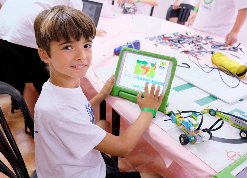 Niño haciendo pruebas en una tablet en el campamento tecnológico