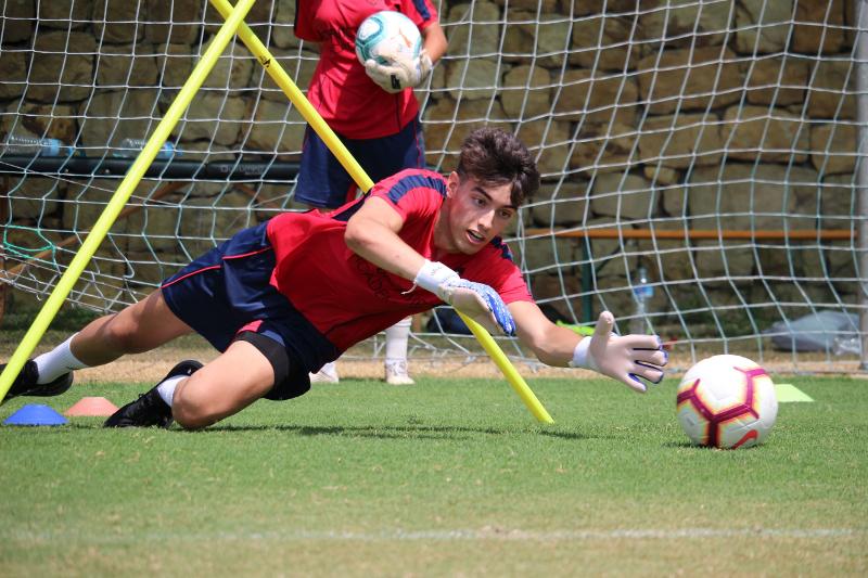joven jugando al fútbol en el puesto de portero en el curso inglés extranjero verano