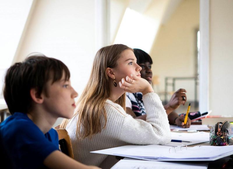  Estudiante escuchando a la profesora en clase de francés en un curso de idiomas en el extranjero