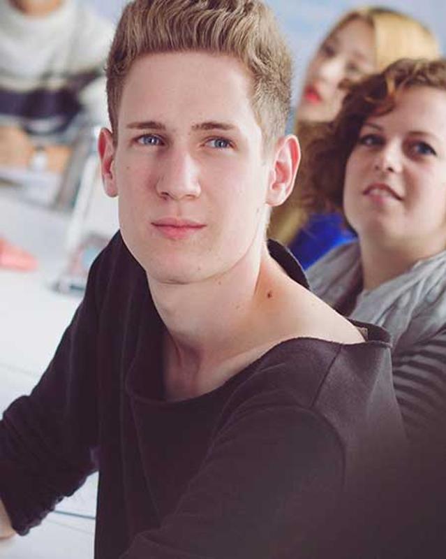 Joven atendiendo en clase en el curso de ingles extranjero