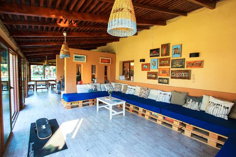 Zona de chill out con sofás y mesa del surfcamp cadiz