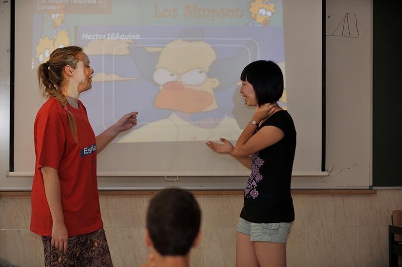 Dos chicas haciendo una presentación en clase de idiomas en el campamento de verano comunidad de madrid