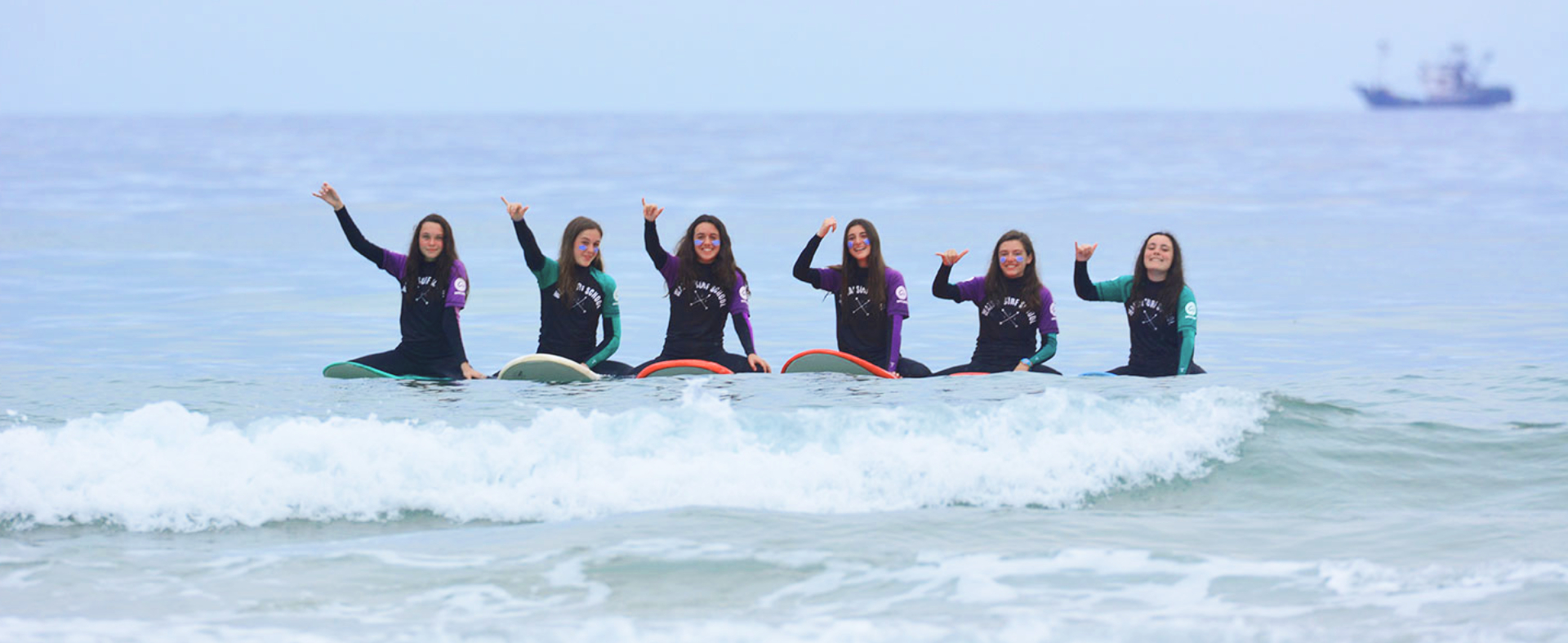Participantes del campamento de verano de surf en el norte de España cogiendo